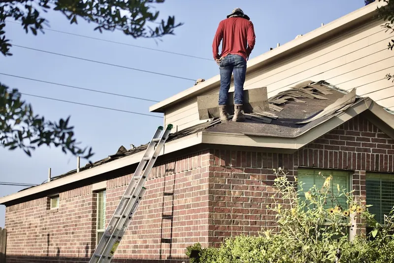 Professional roofer working on a residential roof in Nickerson Gardens